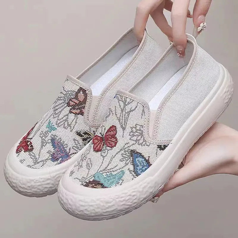 Women's Old Beijing-style slip-on canvas shoes in black or white with a round toe and plastic sole.