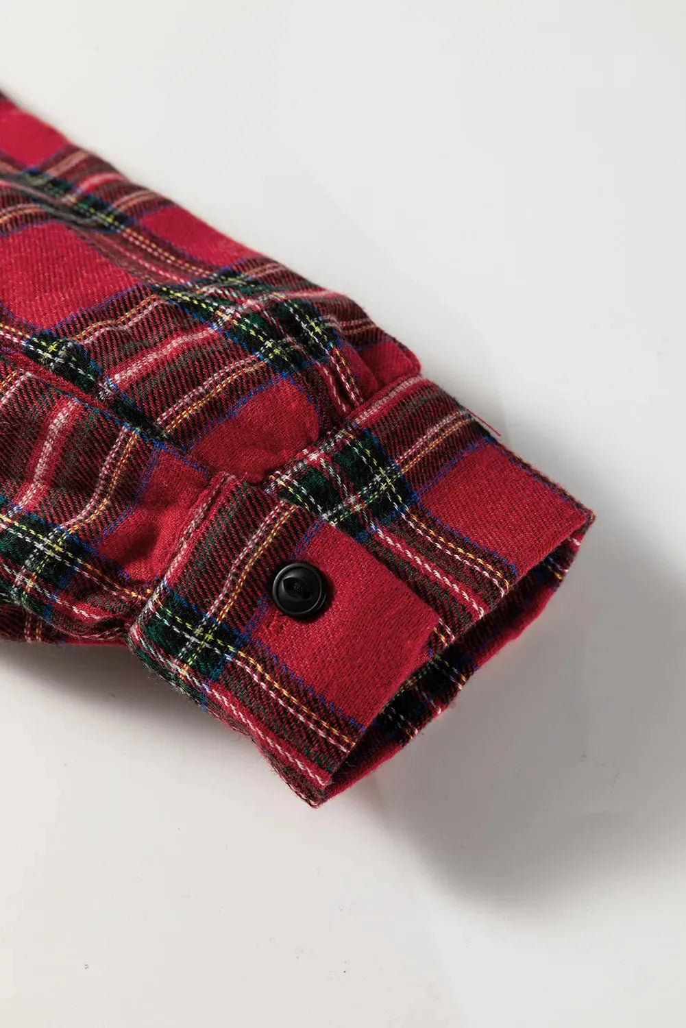 Red and black plaid women's mini dress with a shirt collar, half-button front, long sleeves, and a ruffle hem.