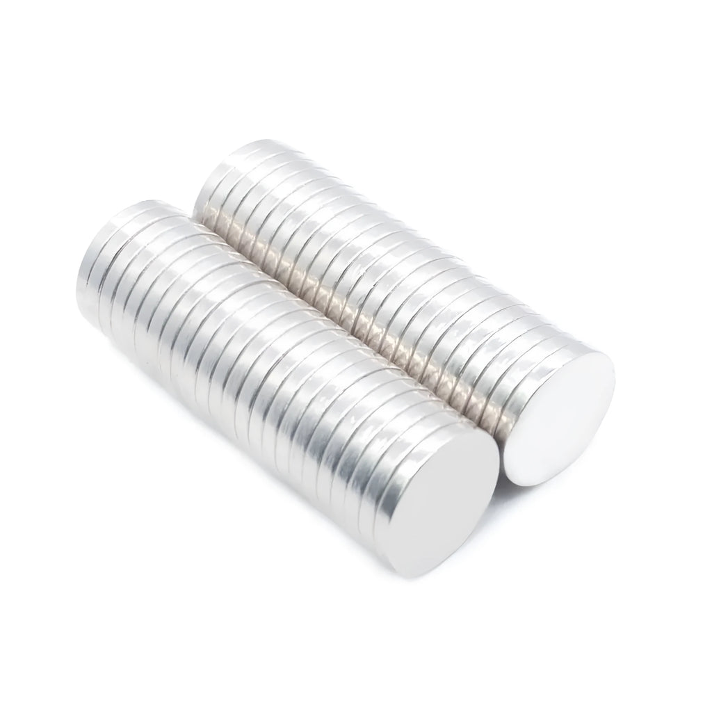 Silver neodymium magnet disc 14x2mm on plain background