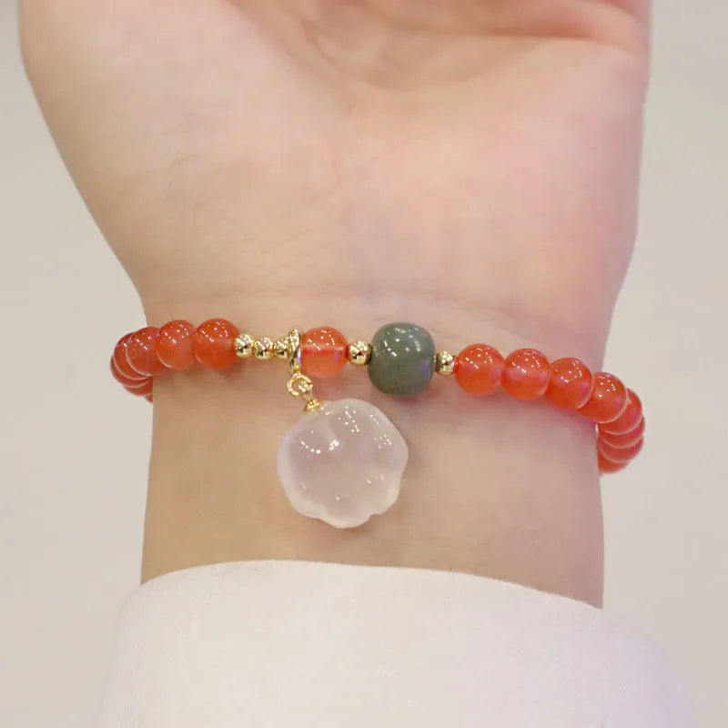 Natural red agate bracelet with jade accents showing 6mm beads and 8mm cat paw zodiac charms