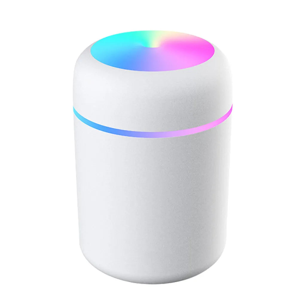 Mini ultrasonic essential oil diffuser with 300ml water tank in white, showing coloured night lights and USB cable