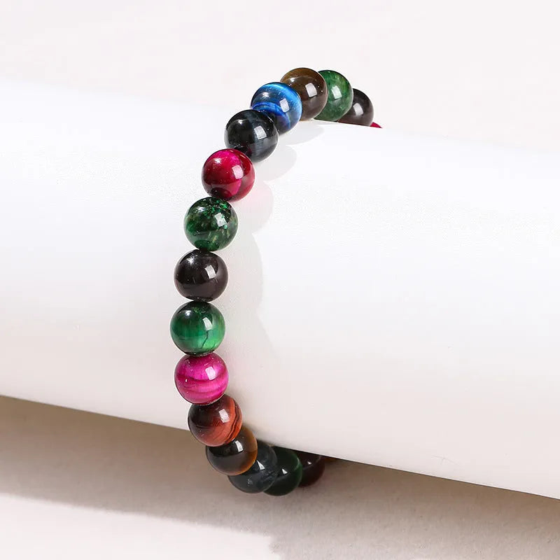 Colourful Tigereye stone bracelet with round beads on a mixed string, showing natural stone variations.