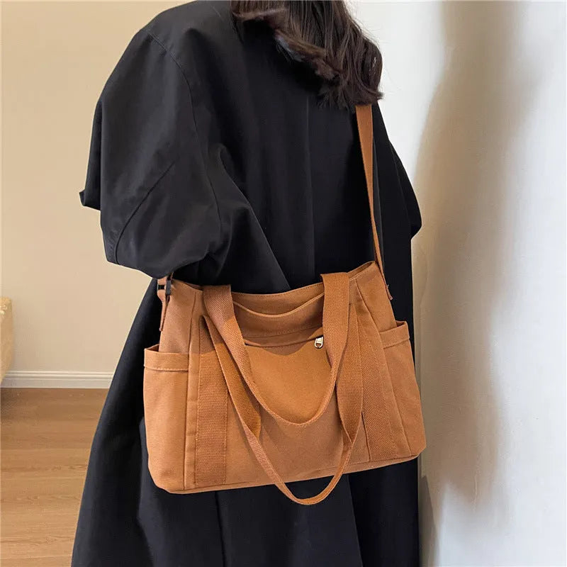 Large canvas shoulder tote bag in solid colour with sandwich pocket organisation