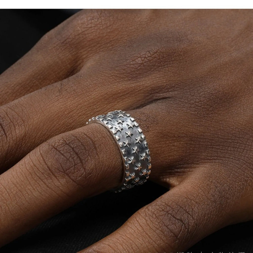 Adjustable opening sterling silver ring with a multi five-pointed star geometric pattern.