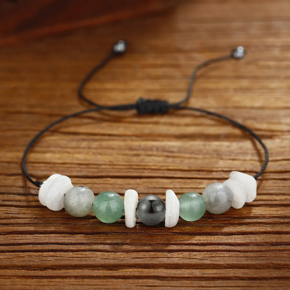 Women's geometric stone bead bracelet in earthy colours on a wrist, showcasing angular bead shapes.