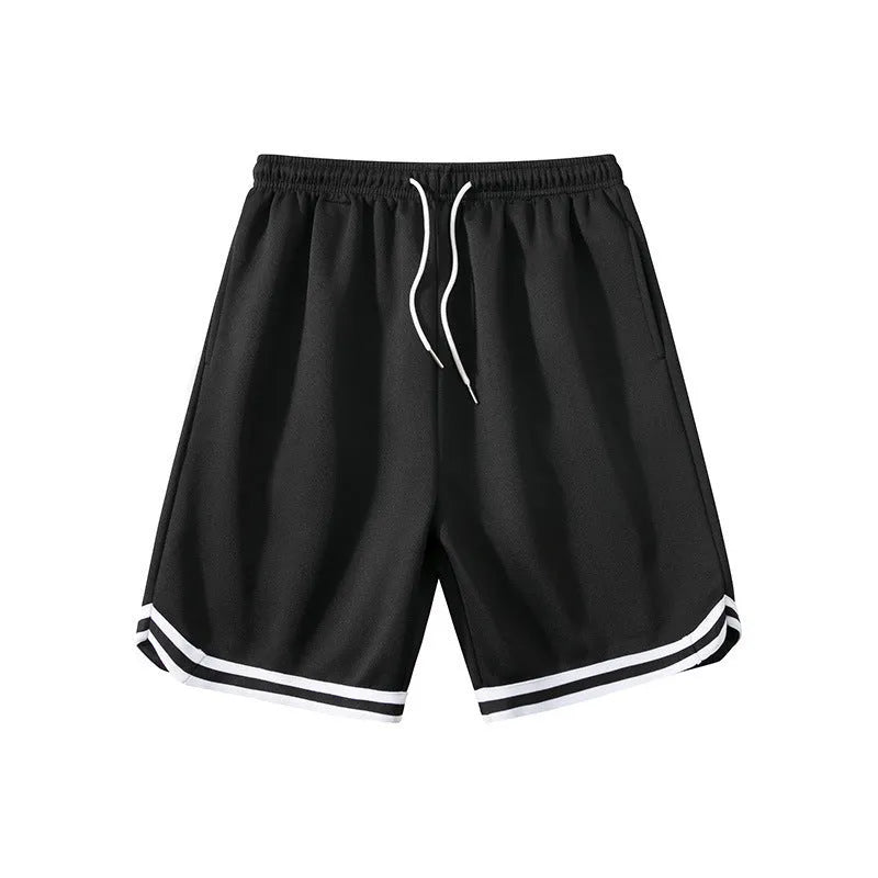 Man wearing loose grey polyester sports shorts with an elasticated waistband.
