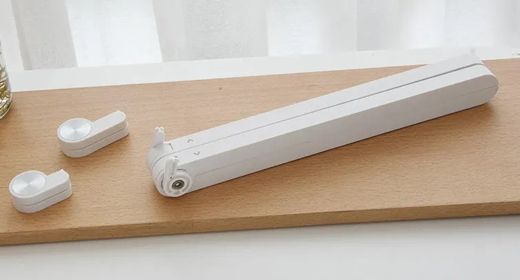 White foldable laptop bracket with heat sink base on a desk.