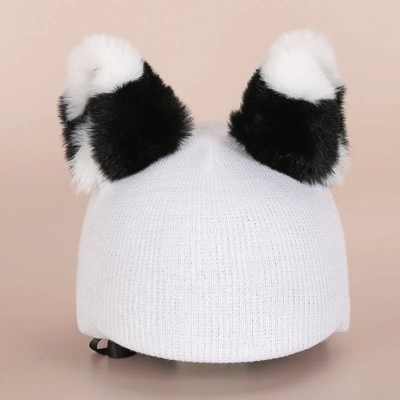 Plush fabric cartoon character decoration cover placed on a ski helmet.