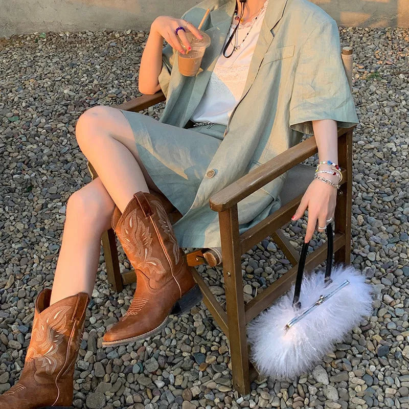 Brown women's mid-calf embroidered Martin boots with a leather lining and a low square heel.