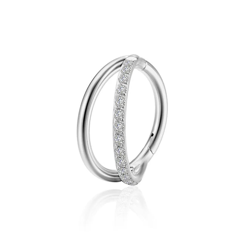 Titanium alloy nose ring body jewellery in silver colour on a plain background.