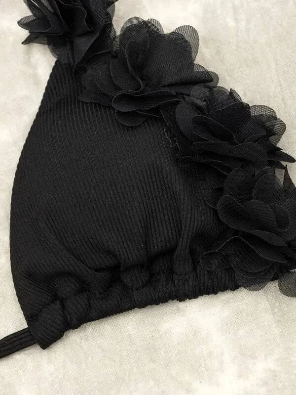 Black women's bikini set with gathered ruffle detail on top and matching shorts