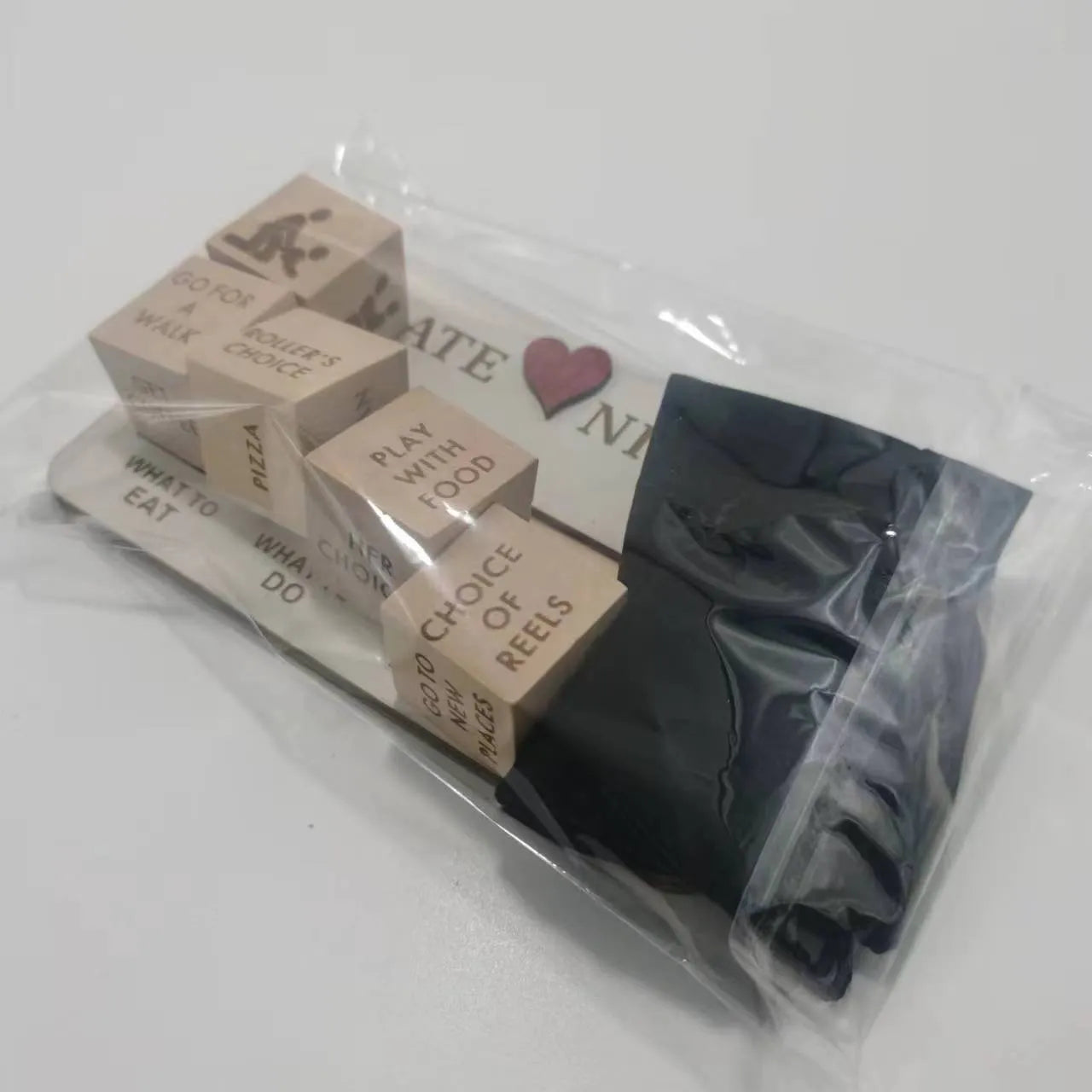 Wooden date night dice set for couples showing five dice, a rectangular planner board, and a black storage bag.