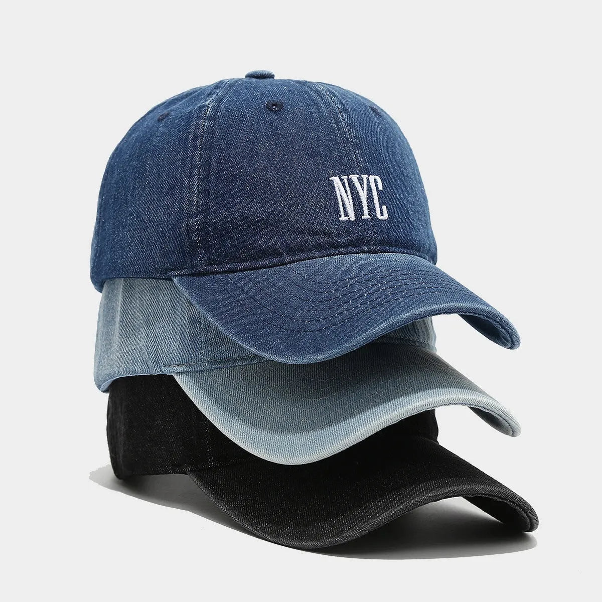 Retro style denim peaked cap with a large alphabet letter on the front, shown in light blue.