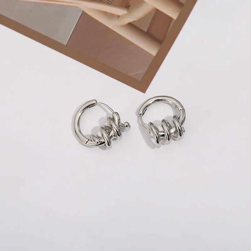 Spiral wound ear clip earrings in frosted geometric shape, copper with gold or silver plating, 1.75cm by 2.16cm.
