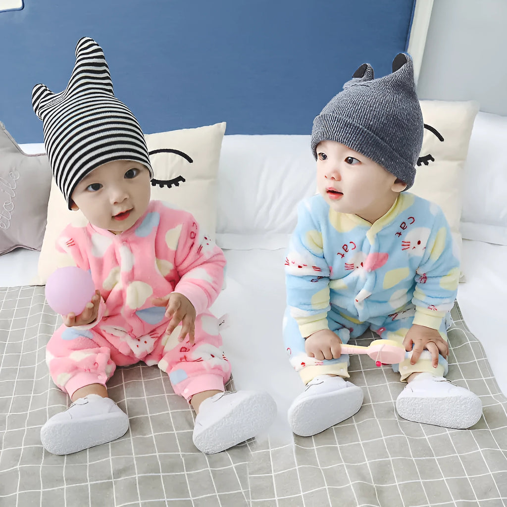 Baby wearing a long sleeve flannel romper in a panda or dinosaur print.