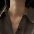 S925 sterling silver necklace with a geometric pendant holding a round jelly opal, plated in gold.