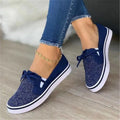 White canvas lace-up flat shoes for women with cross strap design and round toe