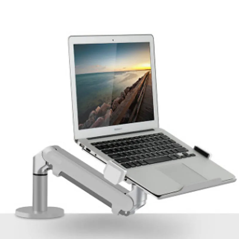 Silver aluminium Free Hover adjustable laptop and monitor arm bracket extended on a desk.