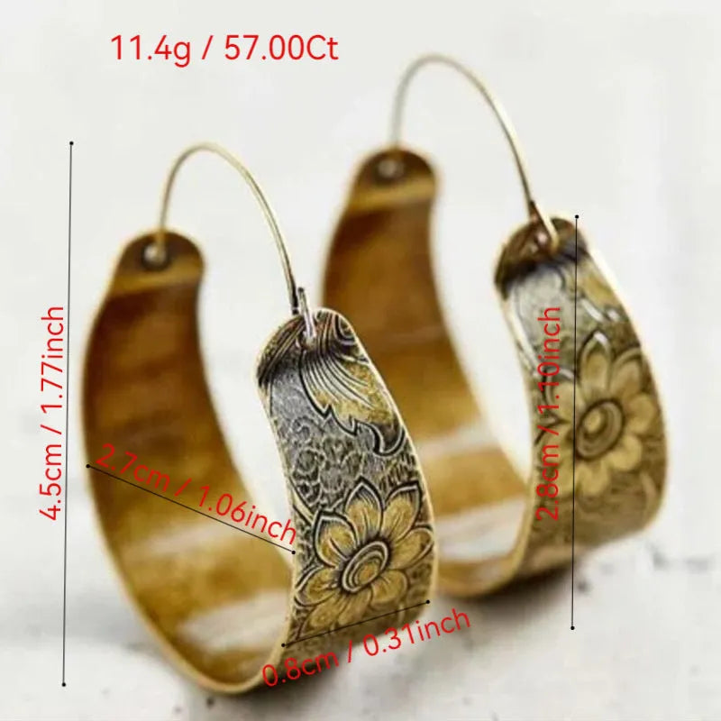 Gold coloured women's earrings with an intricate hollow petal design in a geometric Maillard style.
