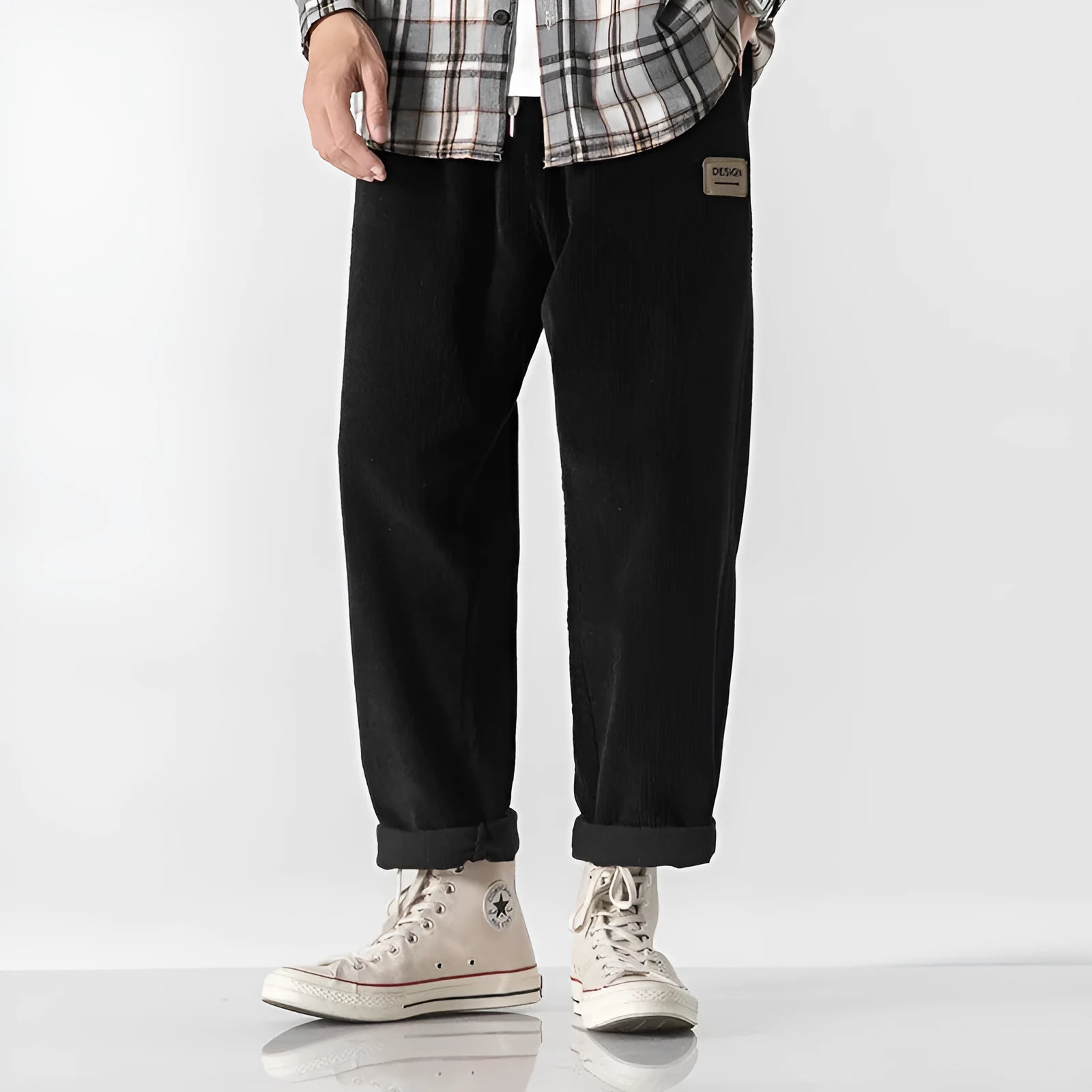 Men's loose straight corduroy sports trousers in Army Green on a grey background.
