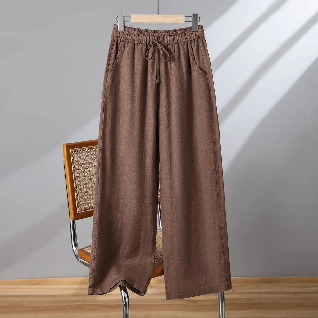 Women's straight-leg casual trousers in apricot colour with an elastic waistband and lace-up drawstring detail.