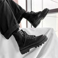 Black men's Dr. Martens platform boots with a side zipper and frosted leather upper.