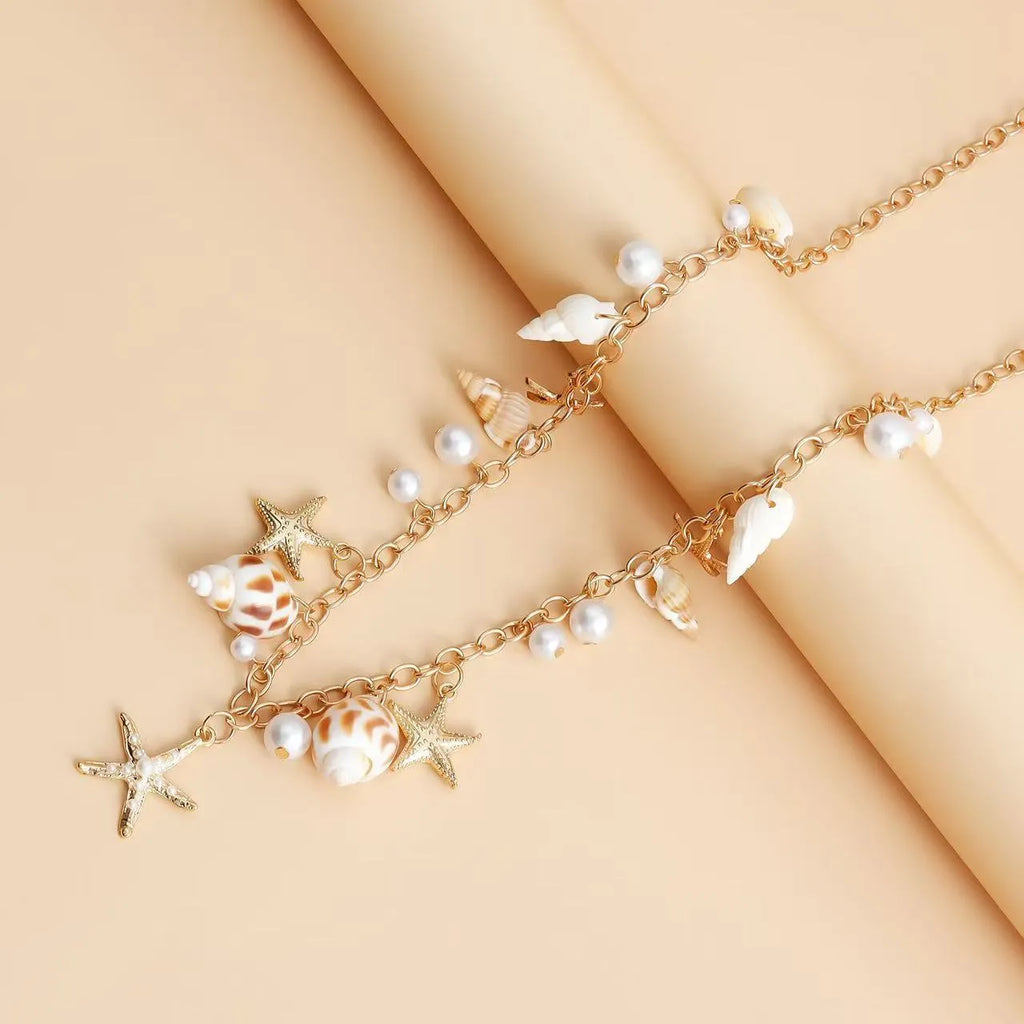 Women's alloy waist chain and matching bracelet set with star charm details on a white background.