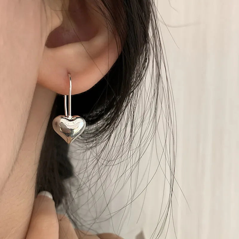 Three-dimensional glossy heart earrings with Korean style design in silver tone
