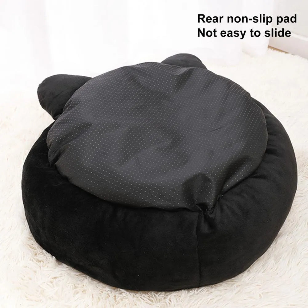 Black cat shaped velvet pet bed with raised edges for feline head and neck support