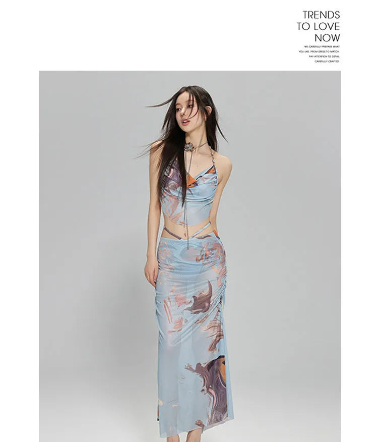 Women's blue printed bikini set with steel support top, pants, and matching skirt laid flat.