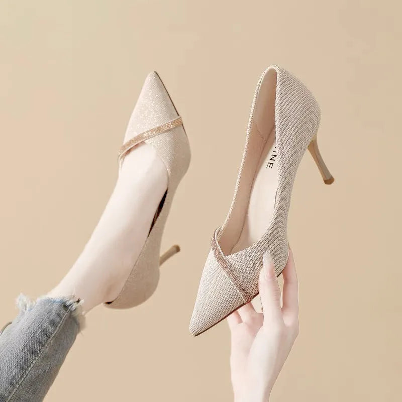 Women's black and gold stiletto high heels with pointed toe design and low-cut silhouette