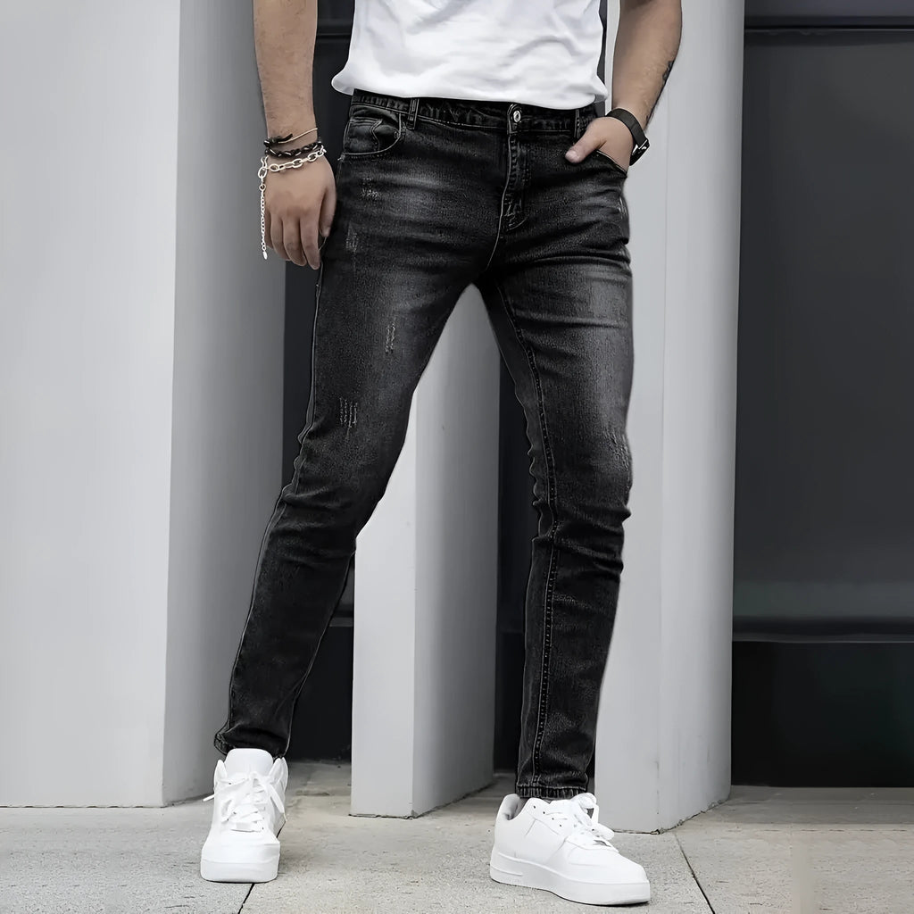 Men's black stretch skinny jeans showing high elasticity cotton-spandex fabric with zipper fly and straight leg cut
