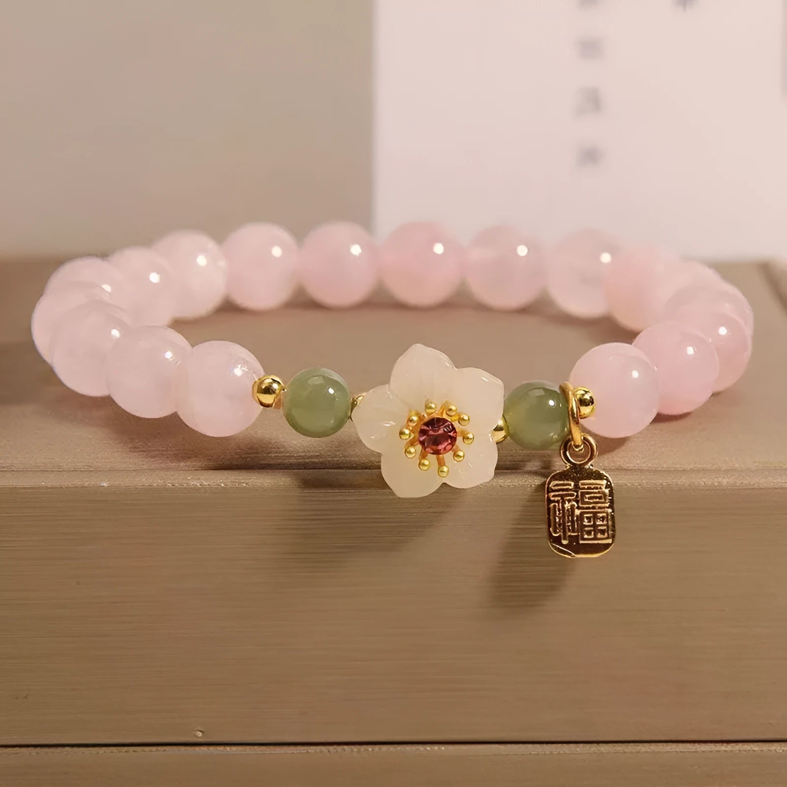 Crystal bracelet with Hetian jade beads, peach blossom charms, and camellia elements in pastoral design