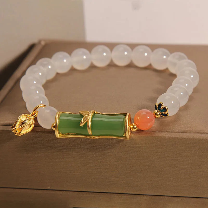 Women's white agate and jade beaded bracelet with bamboo joint connector in retro Chinese style.