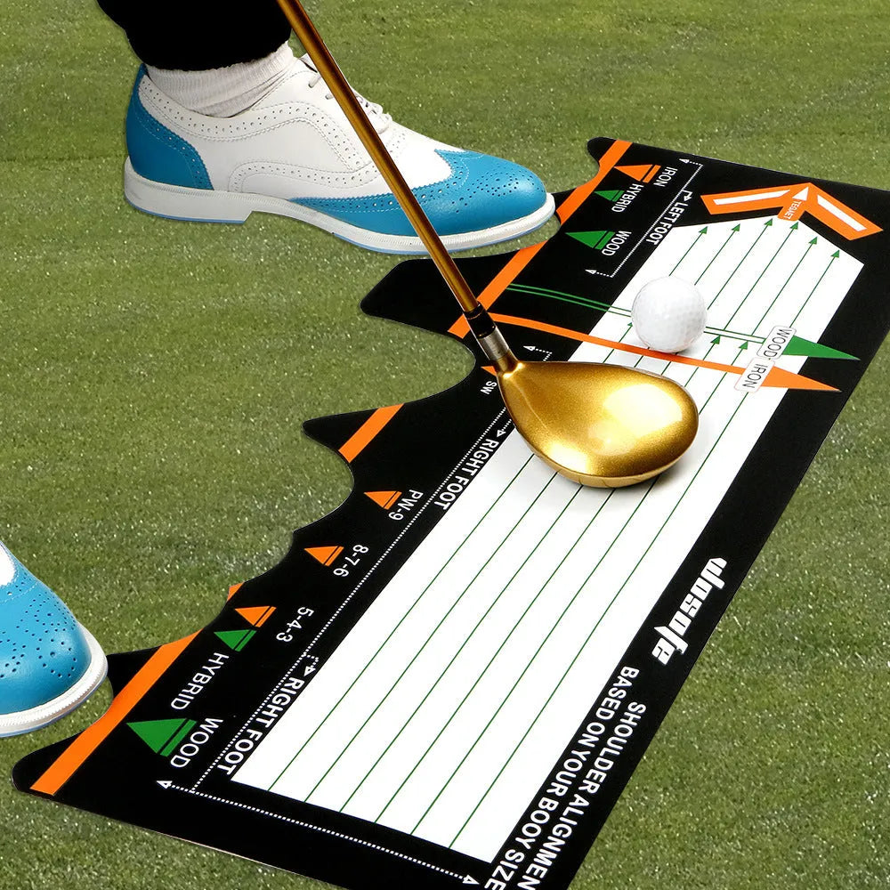 Black neoprene golf swing training pad with alignment markings on a green artificial turf surface.