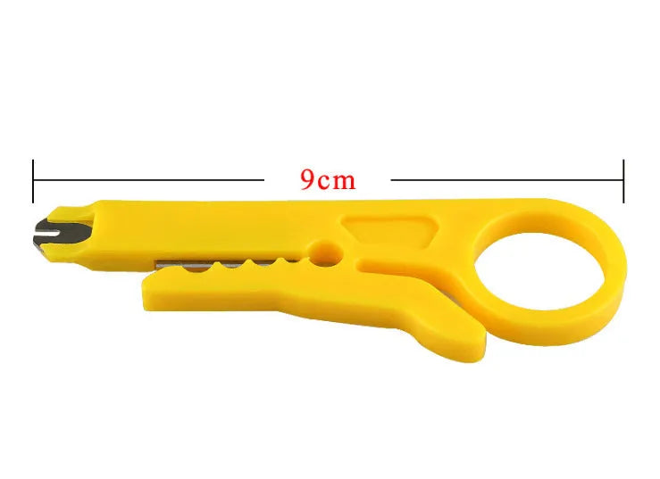 Yellow mini portable wire stripper tool for 0.6mm cables on a workbench.