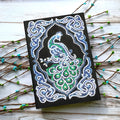 Black A5 diamond painting notebook for creating a peacock-themed journal with shaped drills.