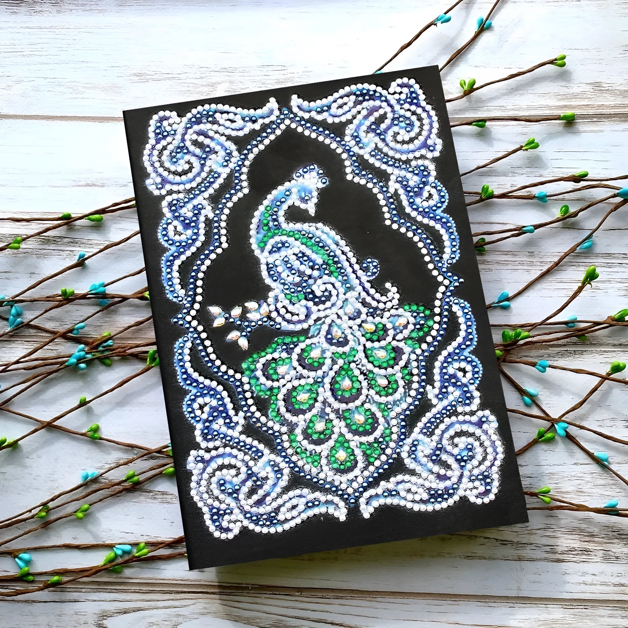 Black A5 diamond painting notebook for creating a peacock-themed journal with shaped drills.