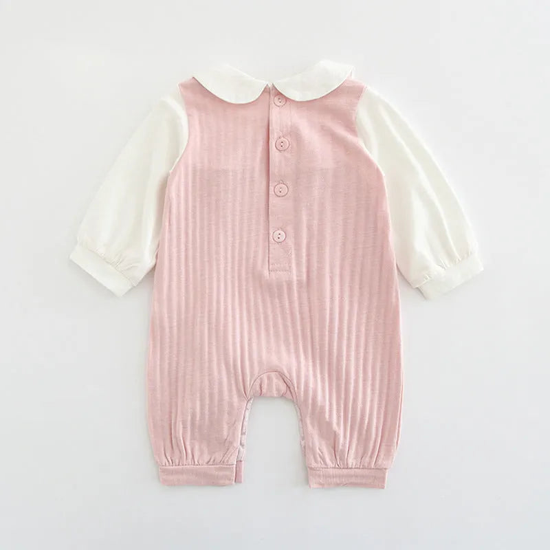 Pink 100% cotton embroidered jumpsuit for a baby girl, with long sleeves and single-breasted closure.