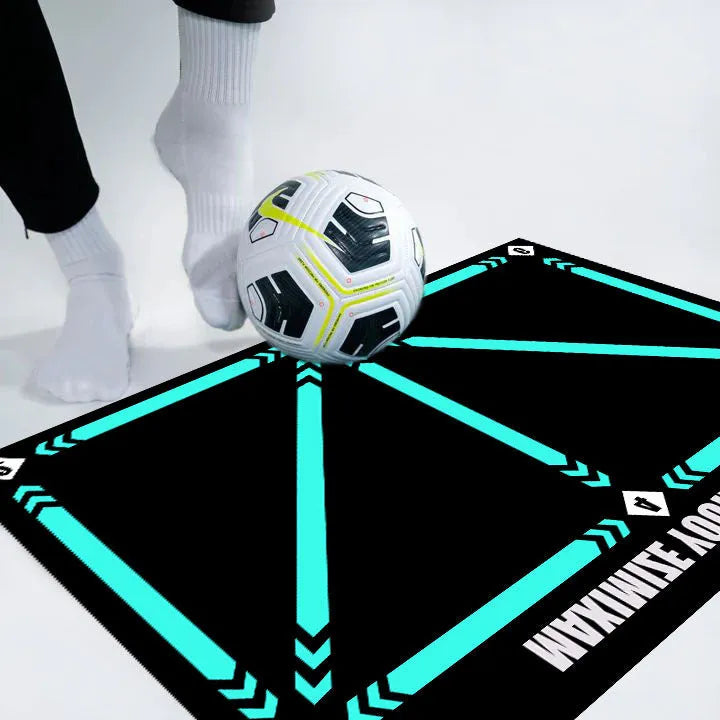 Black rectangular football training mat measuring 60 by 90 cm on a grass surface.