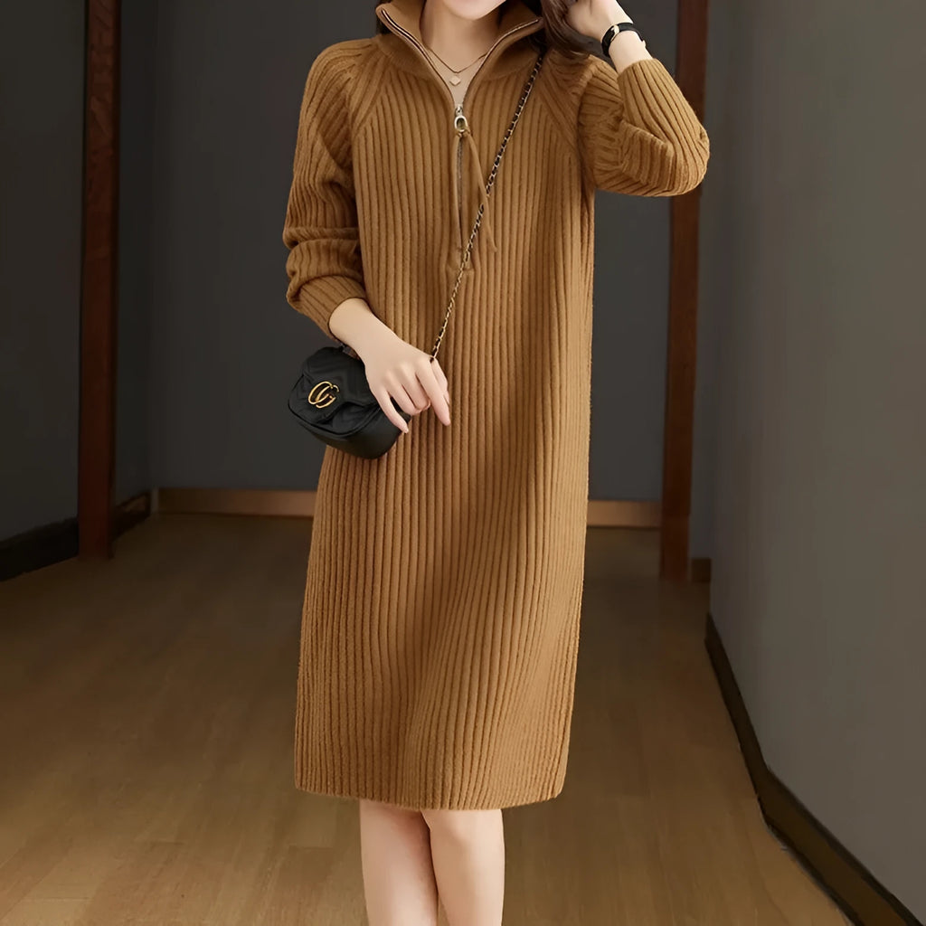 Beige half-zip woolen skirt with stand collar and long sleeves in a loose, straight dress cut.