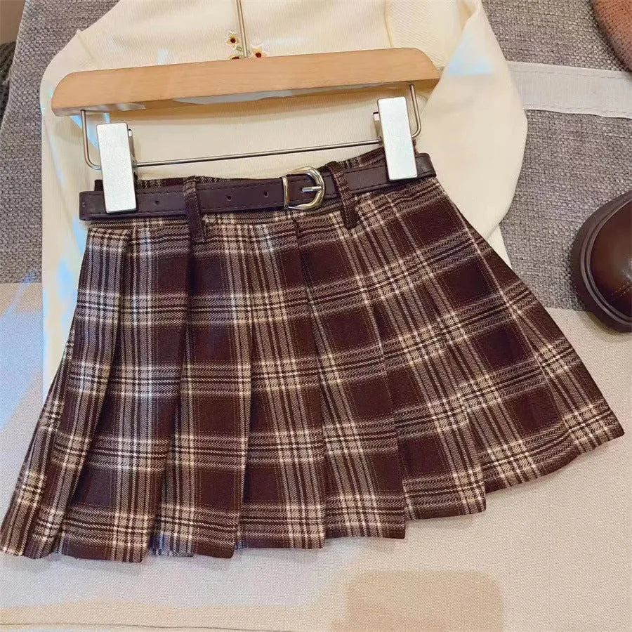 Girls' plaid pleated A-line skirt in a cotton blend fabric, shown on a hanger.