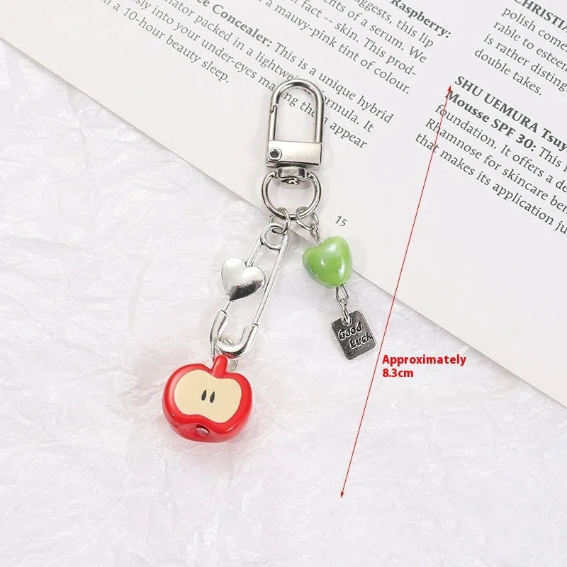Mobile phone charm keychain with fruit designs including apple and strawberry patterns