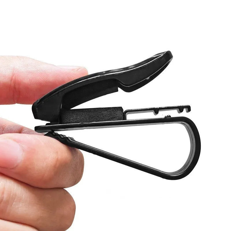 Black plastic clip for car sunshade to hold sunglasses and tickets.