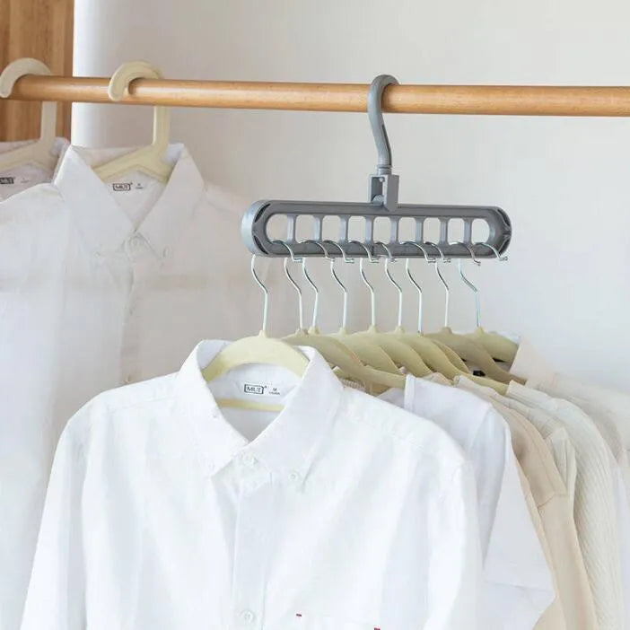 Plastic clothes hanger with a white hook on a pink background, showing its 33 cm length and rotatable handle.
