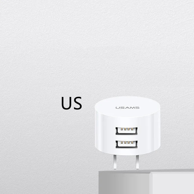 White portable dual USB charger with folding UK, US, and EU plugs showing compact dimensions