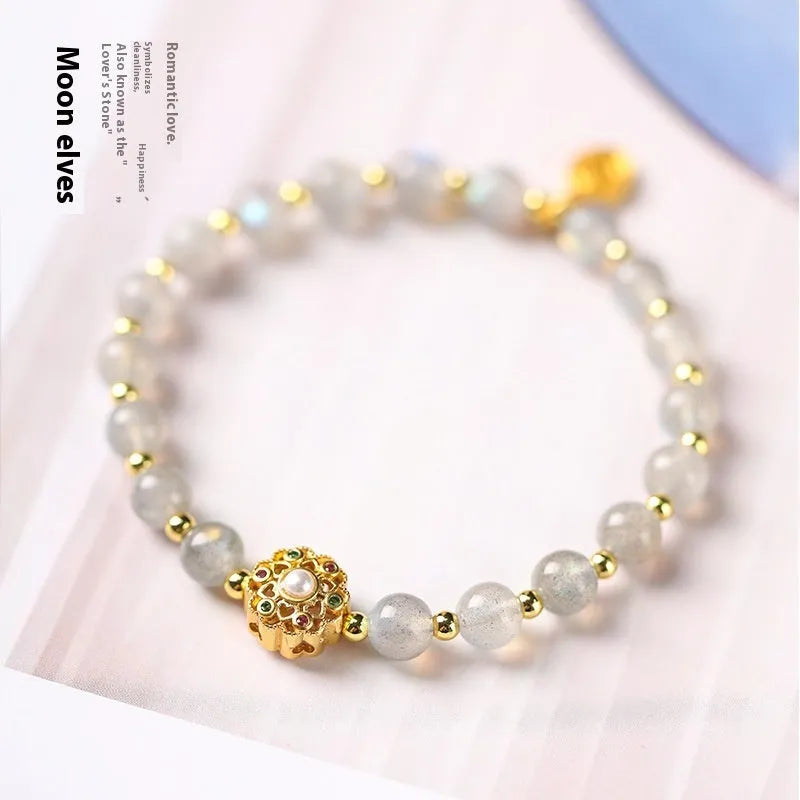 Gray moonstone and pink sunstone crystal bracelet with hand-woven cord and peach blossom quartz charms.