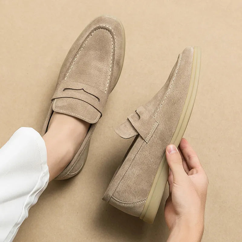 Men's beige leather slip-on casual shoes with a round toe and rubber sole on a white background.