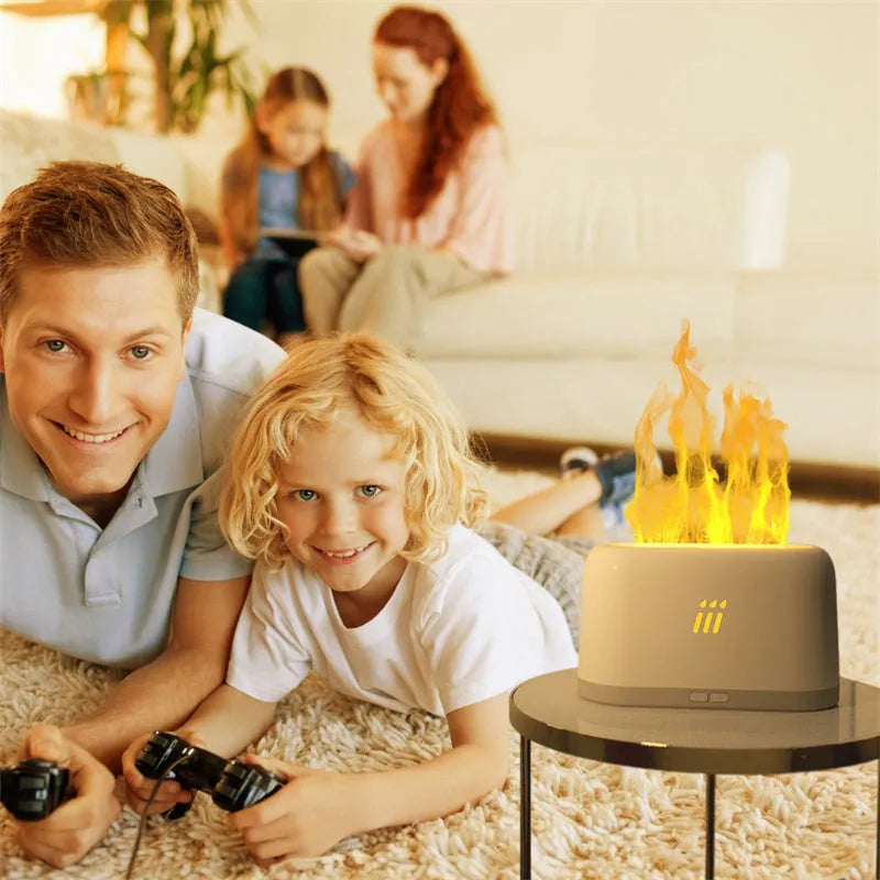 Black round ultrasonic aroma diffuser humidifier with flame effect LED lights and remote control on a table.