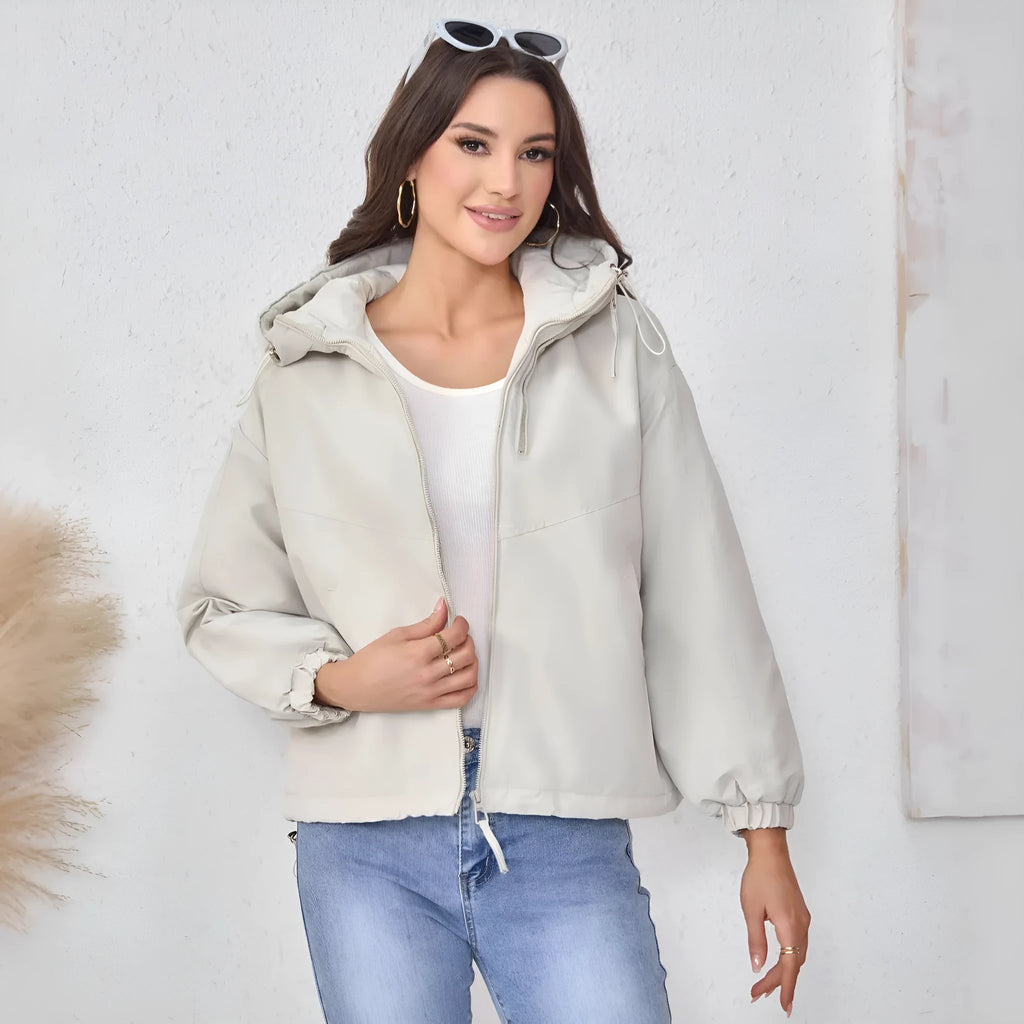 Women's loose-fit hooded shell jacket in grey, black, or purple colours, made from polyester fabric.